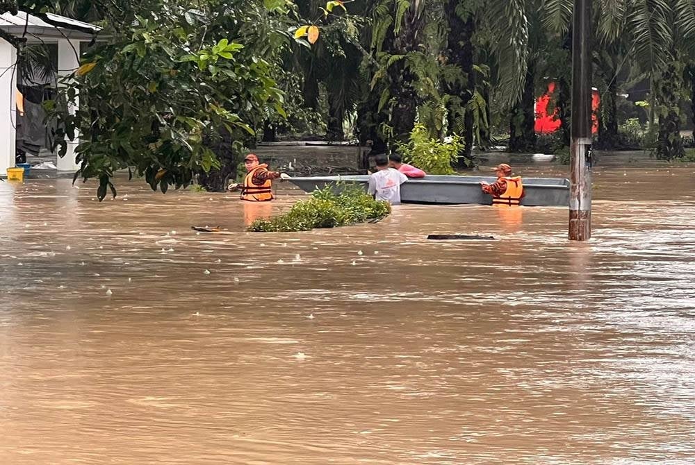 Anggota bomba menyelamatkan 19 mangsa banjir di asrama tahfiz Kampung Baru Sungai Mas, Kota Tinggi pada Sabtu.