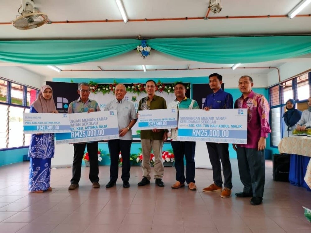 Zulkiflee (tiga dari kiri) ketika menyampaikan sumbangan berkenaan di SK Astana Raja, Rembau pada Khamis.