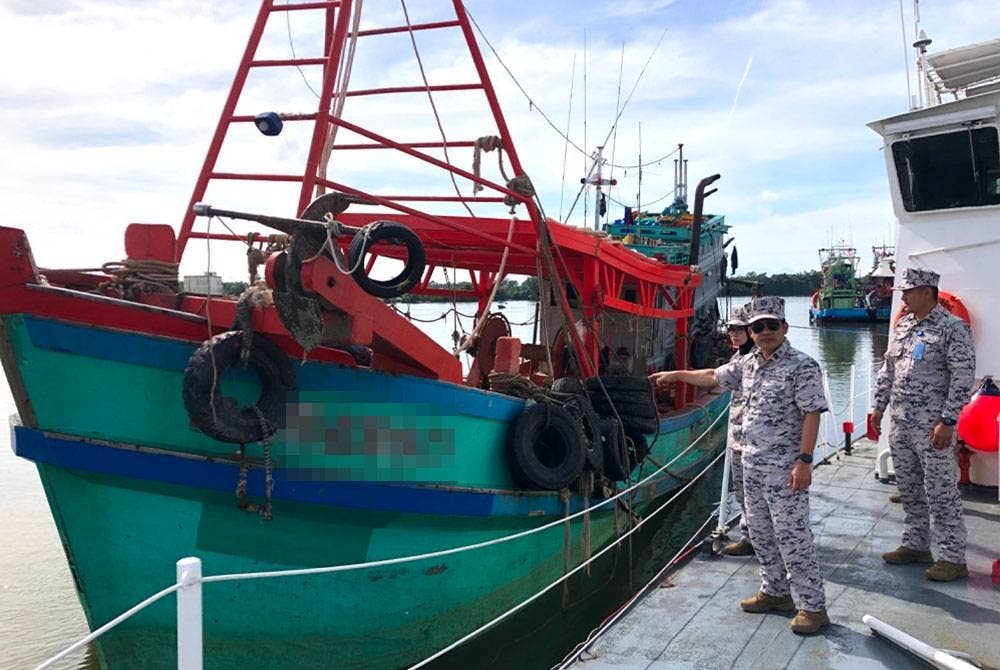 Syed Nor Adli (tengah) menunjukkan bot nelayan asing warga Vietnam yang dirampas oleh Maritim Malaysia Kelantan.
