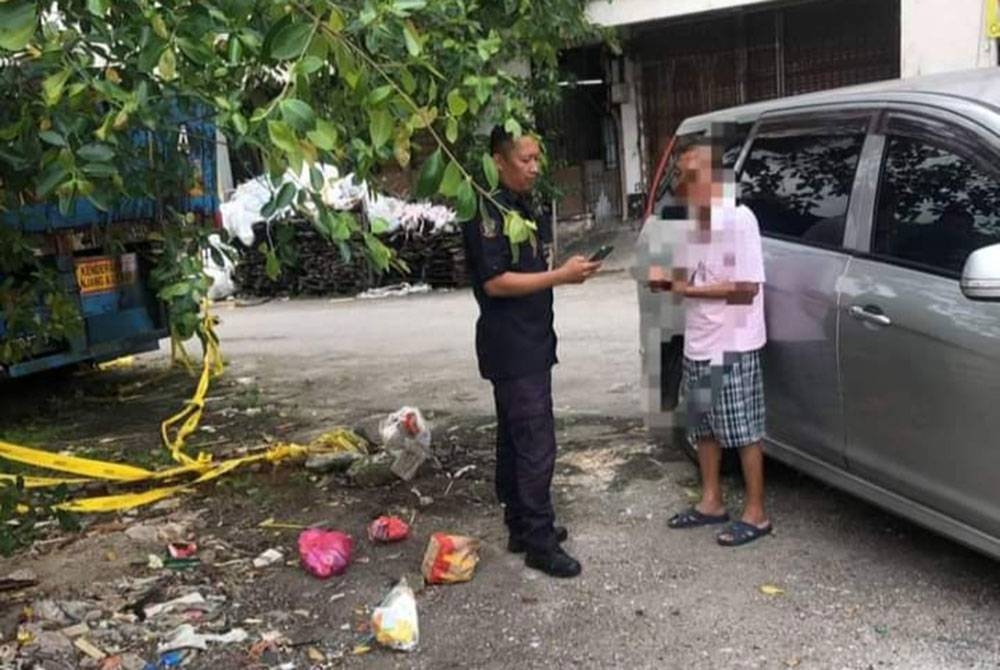Salah seorang individu (kanan) yang dikenakan kompaun setelah didapati membuang sampah di kawasan tidak ditetapkan pihak MPK.