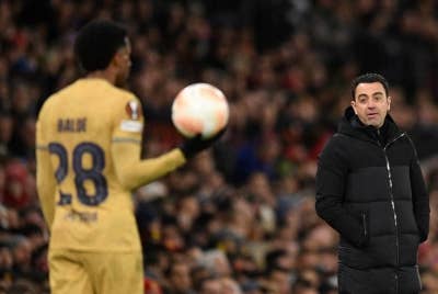 Xavi (kanan) yakin Barcelona akan kembali lebih hebat musim depan. - Foto AFP