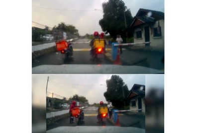 Tular video memaparkan seorang individu(kiri) menendang pengawal keselamatan warga Nepal di hadapan pintu masuk sebuah taman perumahan di sini pada Ahad.