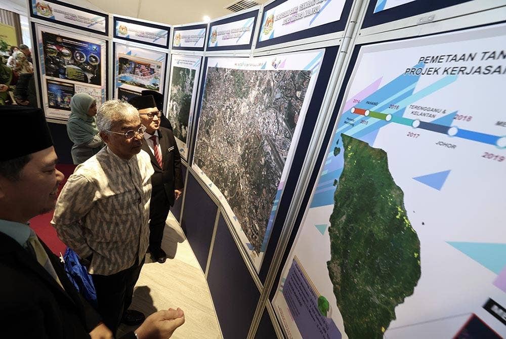 Al-Sultan Abdullah (dua, kiri) berkenan melawat pameran selepas menyaksikan majlis menandatangani MoU berkenaan. - Foto Bernama