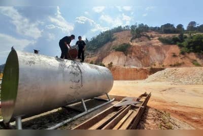 Pegawai dan anggota KPDN Perak melakukan pemeriksaan ke atas skid tank yang disyaki menyimpan minyak diesel bersubsidi. - Foto KPDN Perak