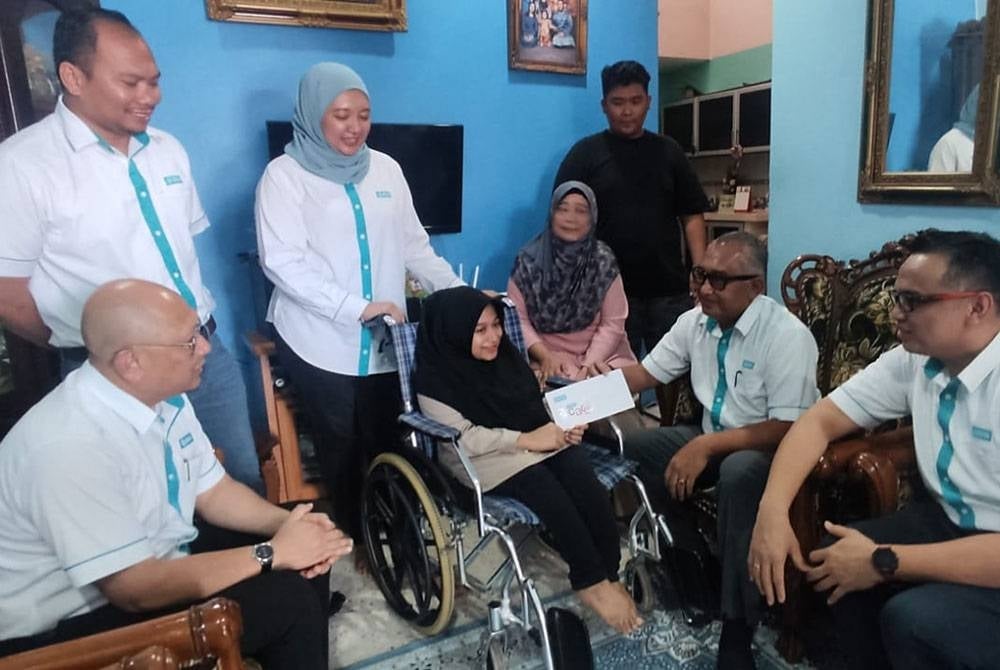 Zamri (dua dari kanan) bersama rombongan BSN menyerahkan sumbangan CSR kepada Putri Nur Damia Danisha di Taman Aman, Alor Setar pada Sabtu.