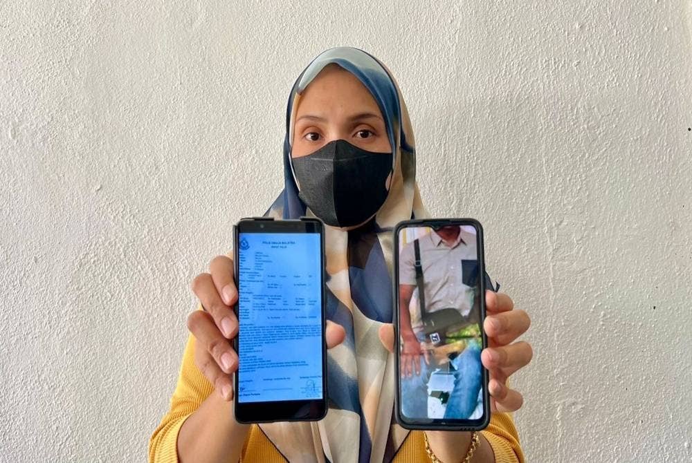 Siti Izrahayu menunjukkan gambar beg silang suaminya berwarna hitam dan salinan laporan polis yang dibuat pada Ahad.