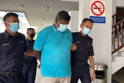 Chandramohgan ketika dibawa keluar dari Mahkamah Majistret di sini, pada Isnin.