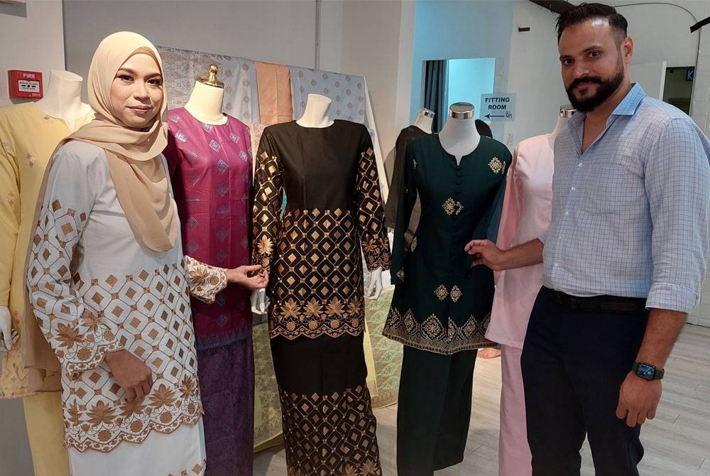 Khairunnisa dan Muhammad Waqas bersama koleksi pakaian songket dan sulam songmet di butik mereka di Bangi.