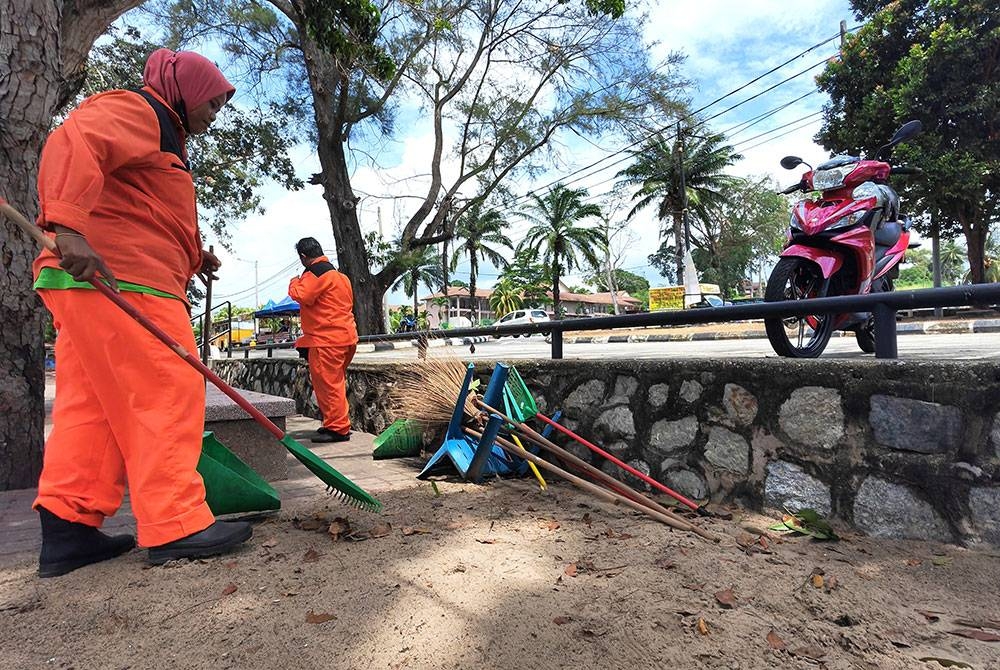 Sharifah sentiasa memastikan kawasan pantai sentiasa bersih.