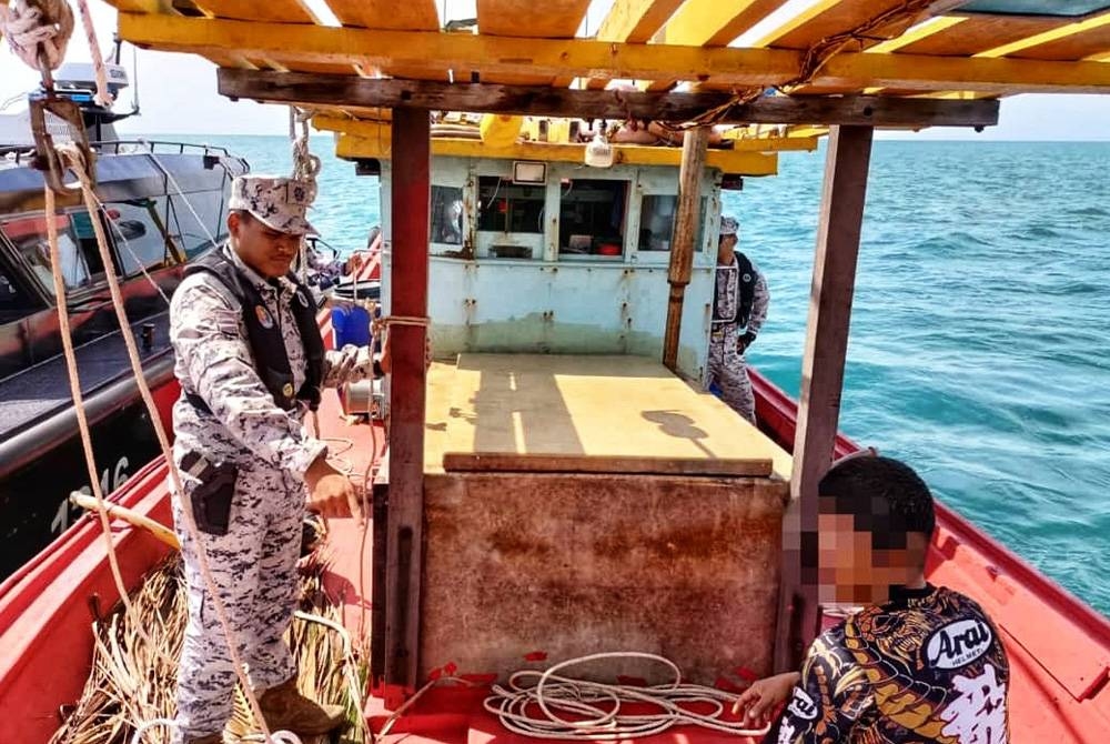 Seorang tekong warga Laos ditemui atas bot tersebut dan tidak memiliki permit kerja sah. - Foto ihsan Maritim Malaysia