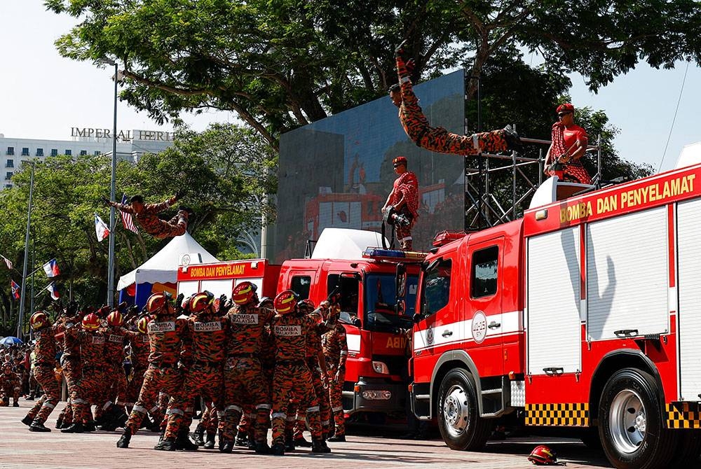 Anggota Bomba dan Penyelamat melakukan aksi berbahaya pada acara pertunjukan sempena Sambutan Hari Bomba Sedunia di Memorial Pengisytiharan Kemerdekaan dekat Banda Hilir hari ini. - Foto Bernama