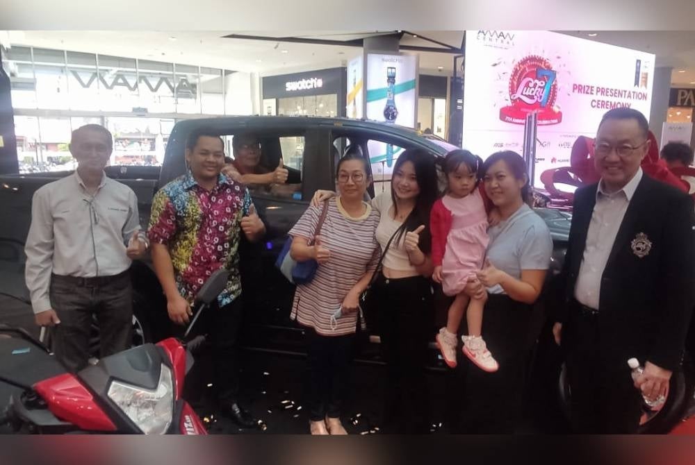Pemenang cabutan bertuah utama ulang tahun ketujuh pusat membeli-belah Aman Central, Milas Chong Khar Hooi (empat kanan) bersama keluarganya dan tetamu kenamaan yang hadir ke program tersebut pada Jumaat.