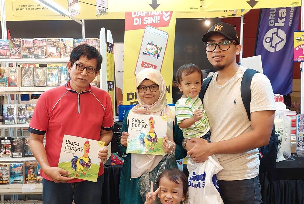 Basari (kiri) bergambar bersama Ajma dan keluarganya yang membeli buku Siapa Punya? di PBAKL pada Rabu.