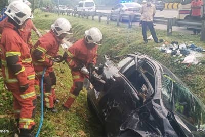 Anggota bomba mengeluarkan mangsa yang terlibat dalam kemalangan di Lebuhraya Karak berhampiran Kampung Sungai Chinchin, pada Selasa.