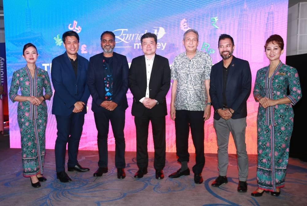 Philip (dua dari kiri) pada pelancaran EnrichMoney di Hotel Grand Hyatt di sini pada Isnin.