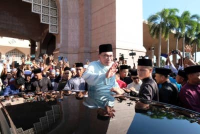 Anwar melambai tangan ke arah para jemaah selepas menunaikan solat sunat Aidiladha di Masjid Putra hari ini. - Foto Bernama