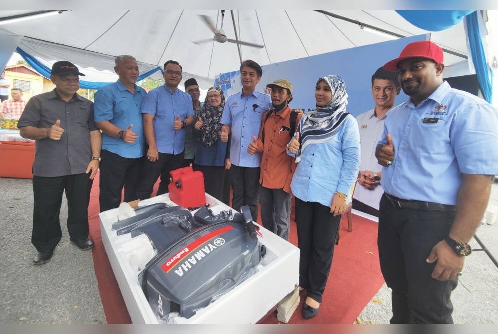 Muhammad Faiz (empat dari kanan) bergambar semasa penyampaian peralatan penangkapan semasa Majlis Rahmah Mesra Madani Pengerusi LKIM Bersama Nelayan Kuala Selangor pada Jumaat.