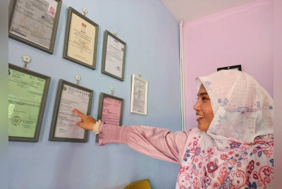 Tina menunjukkan dokumen kelayakan dan sijil-sijil kursus diperlukan bagi kendalian sebuah taska ketika ditemui pada Sabtu.