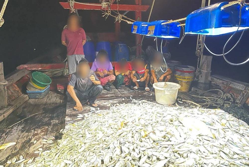Kru, tekong dan bot ditahan bersama ikan campur seberat 1.5 tan telah diiring masuk ke Jeti Maritim Malaysia Bukit Malut untuk siasatan lanjut. - Foto Maritim Malaysia