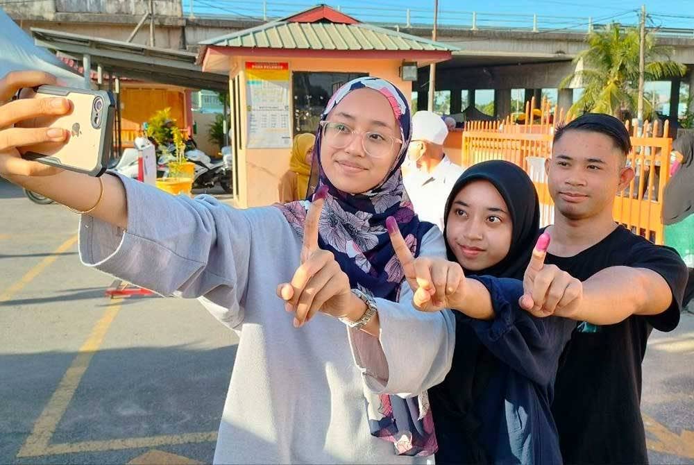 Nurul Aisha (kiri) bersama kakak, Alani Fatini dan abangnya, Firas Faiq sempat merakamkan swafoto selepas selesai mengundi.