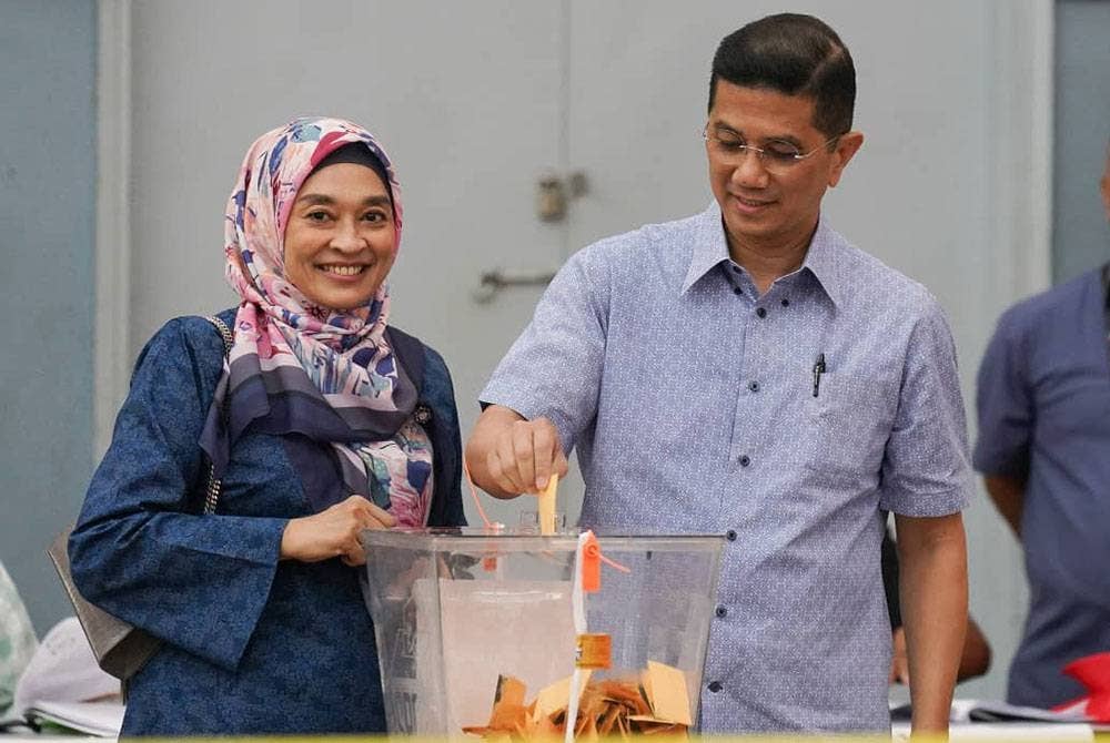 Mohamed Azmin bersama isteri, Datin Seri Shamsidar Taharin membuang undi di Sekolah Kebangsaan Klang Gate pada Sabtu.