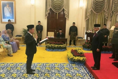 Kon Yeow (kiri) mengangkat sumpah di hadapan Yang di-Pertua Pulau Pinang, Tun Ahmad Fuzi Abdul Razak pagi Ahad.