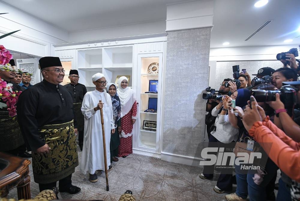 Sanusi hadir bersama isterinya, Tok Puan Jusmalailani Jusoh (kanan) ketika tiba di pejabatnya di Pejabat Menteri Besar, Wisma Darul Aman hari ini. Turut sama ibu bapa beliau, Md Nor Taib (dua dari kiri) dan Meriam Ahmad (dua dari kanan).