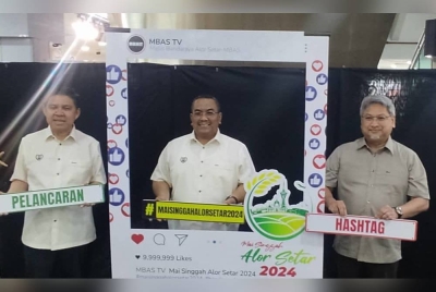 Muhammad Sanusi (tengah) melancarkan Kempen Kibar Jalur Gemilang Peringkat Negeri Kedah di sebuah pasar raya, Alor Setar pada Selasa.