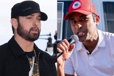 Eminem (kiri) meminta Ramasamy (kanan) berhenti menyanyi lagu Eminem ' Lose Yourself' semasa kempen. - Agensi