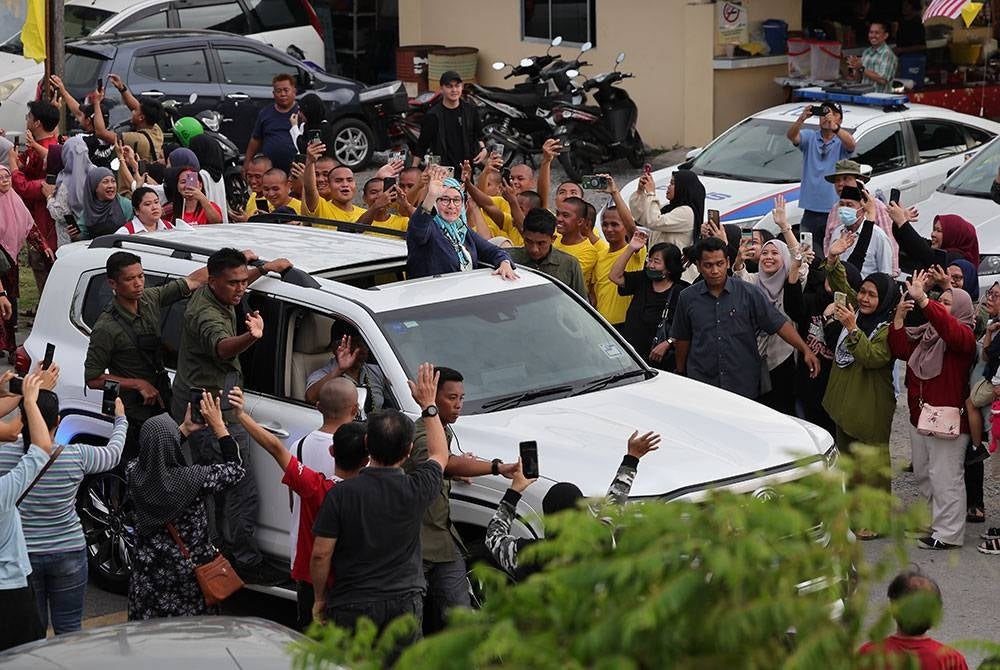 Al-Sultan Abdullah dan Tunku Azizah berkenan melambaikan tangan ketika berangkat pulang selepas majlis Minum Petang Bersama Komuniti sempena Kembara Kenali Borneo di Kampung Pangkalan Lutong. - Foto Bernama