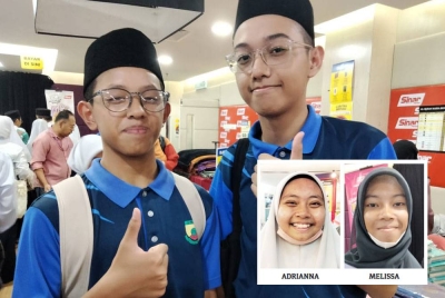Qays Dean (kiri) bersama rakannya, Syed Mohammad Aqil Syed Mohd Redza teruja mengunjungi jualan gudang di Kompleks Kumpulan Karangkraf pada Jumaat.