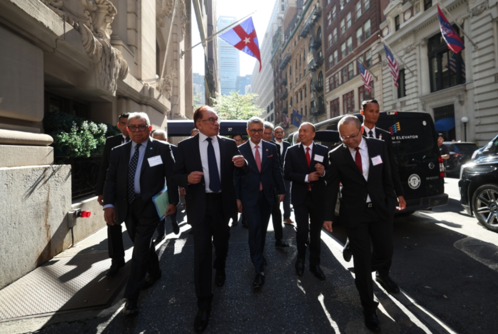 Perdana Menteri Datuk Seri Anwar Ibrahim berjalan kaki dari tempat penginapan ke majlis Invest Malaysia. - Foto Bernama