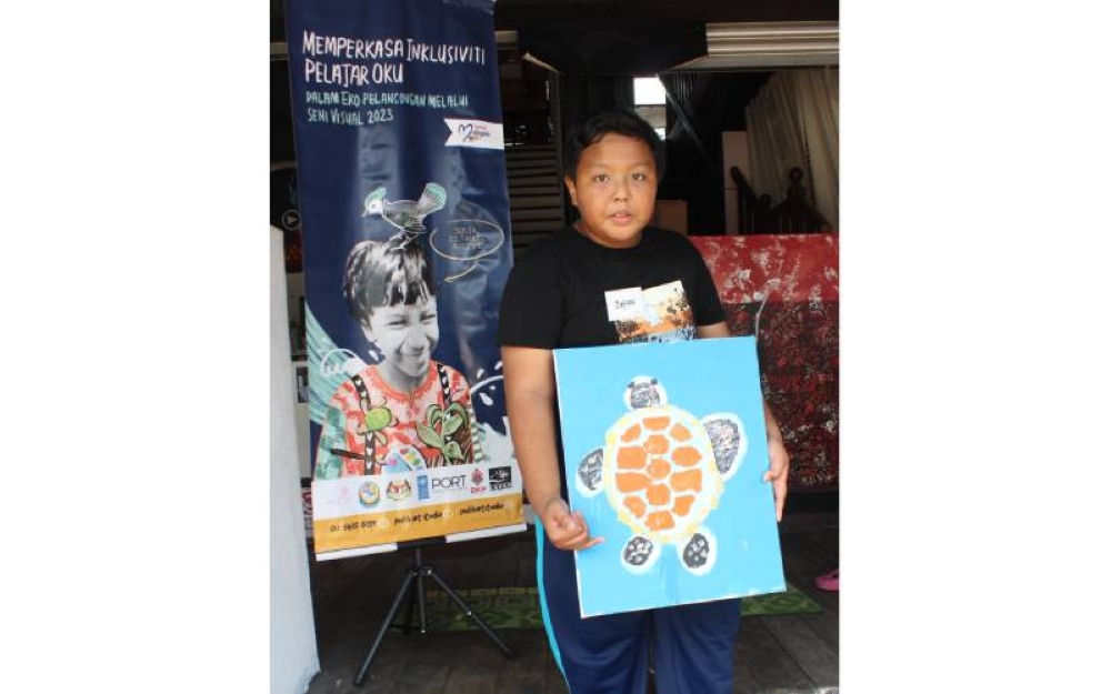 Muhammad Zafran Razali, pelajar Kurang Upaya Intelektual dari PPKI Sekolah Kebangsaan Seri Bayu menunjukkan hasil karyanya. 