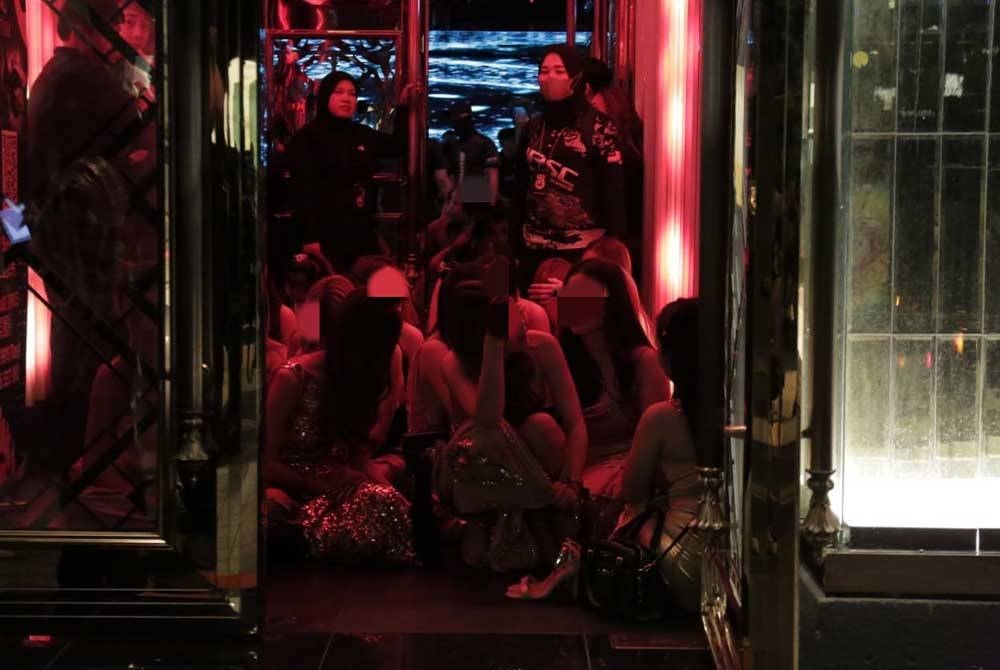 Antara wanita warga asing yang ditahan dalam serbuan di sebuah pusat hiburan di ibu negara, pada Jumaat.