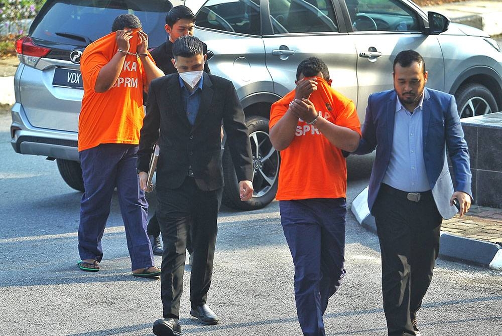 Tertuduh diiring pegawai SPRM ker mahkamah.