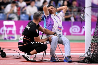 Zankawi (kiri) cuba membantu pegawai olahraga yang mengalami kesakitan. - Foto AFP