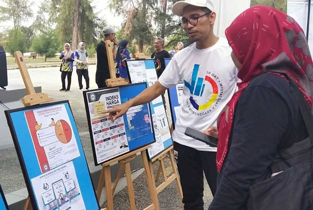 Razaman memberikan penjelasan berkaitan statistik yang dikeluarkan DOSM Pahang kepada pengunjung Program FitDOSM Perdana di Taman Gelora pada Sabtu.