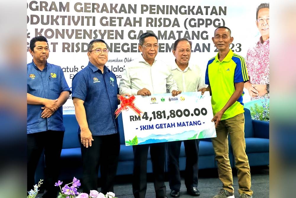 Ahmad Zainal (dua dari kiri) dan Jalaludin (tiga dari kanan) menyampaikan Anugerah Pekebun Kecil.