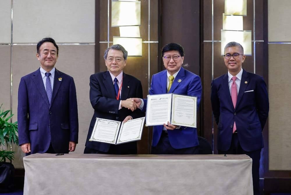 Tengku Zafrul (kanan) bersama Duta Jepun Ke Malaysia, Katsuhiko Takahashi (kiri) menyaksikan pertukaran dokumen perjanjian persefahaman antara JCCI dan FMM. - Foto Bernama