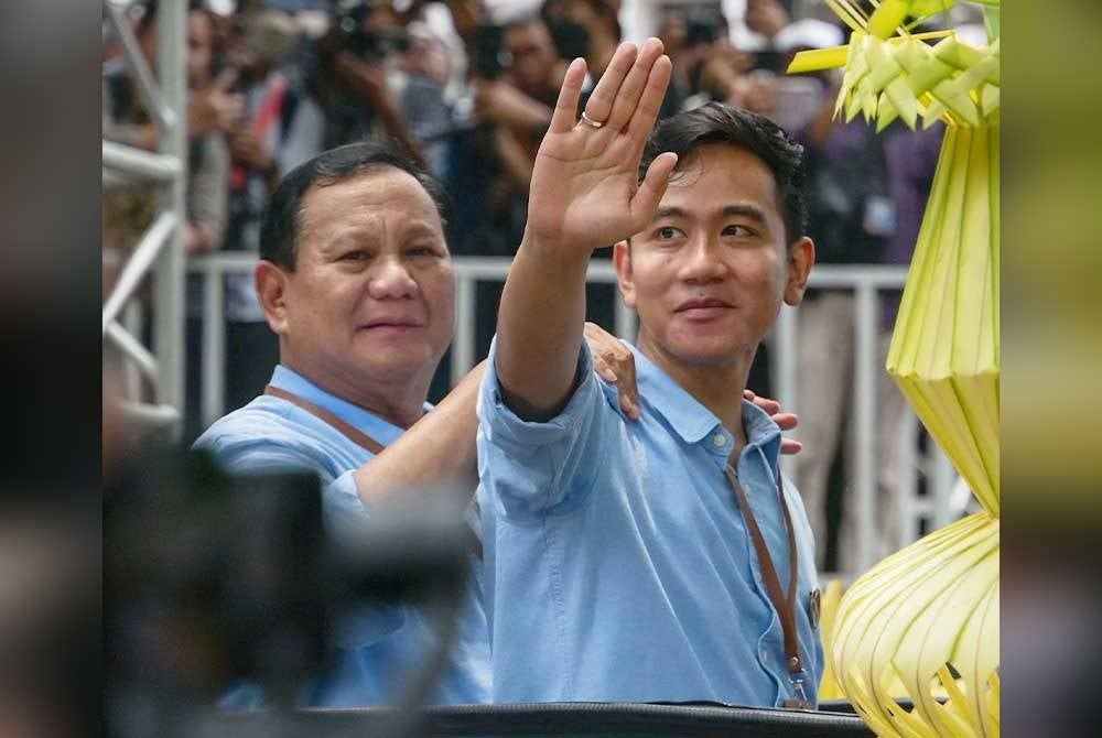Calon Presiden dan penyandang Menteri Pertahanan, Prabowo Subianto dan calon naib presiden dan penyandang Datuk Bandar Solo Gibran Rakabuming Raka (B) yang juga anak Presiden Joko Widodo, menyambut penyokong mereka ketika mendaftar sebagai calon di Suruhanjaya Pilihan Raya Umum pada Jakarta pada 25 Oktober 2023. Foto: AFP