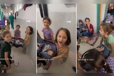 Sekumpulan empat kanak-kanak perempuan sedang bermain permainan 'paramedik dan syuhada'. - Foto Agensi