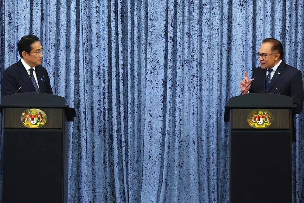 Anwar (kanan) bersalaman dengan rakan sejawatannya dari Jepun, Fumio Kishida selepas sidang media bersama di Seri Perdana hari ini. - Foto Bernama