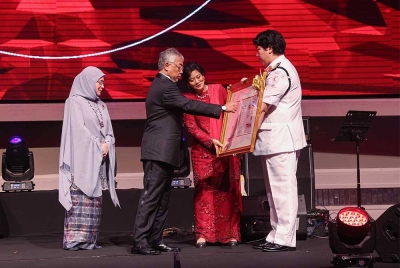 Yang di-Pertuan Agong berkenan menerima cenderahati daripada PBSM yang disaksikan Pengerusi Kebangsaan PBSM, Tan Sri Tunku Puteri Intan Safinaz Almarhum Tuanku Abdul Halim Mu'adzam Shah pada Makan Malam Amal sempena Sambutan Ulang Tahun ke-75 PBSM malam Sabtu. - Foto: Bernama