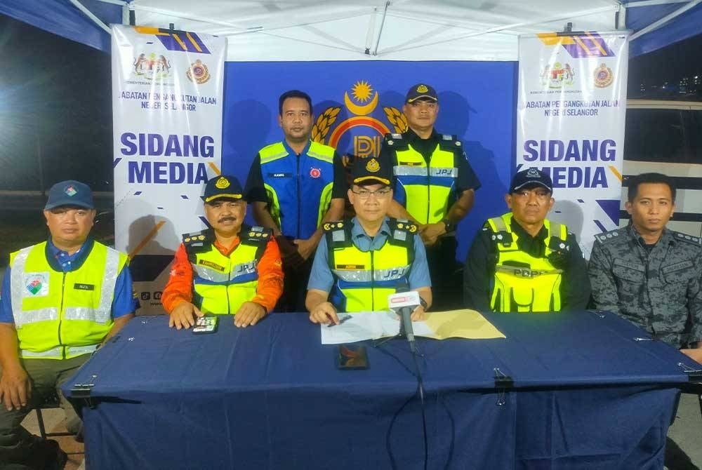 Azrin (duduk, tengah) bersama rakan setugas daripada pelbagai agensi penguatkuasaan semasa pelaksanaan Ops Patuh Bersepadu JPJ dan JSPT di Plaza Tol Sungai Ramal, Kajang, Selangor pada Rabu.