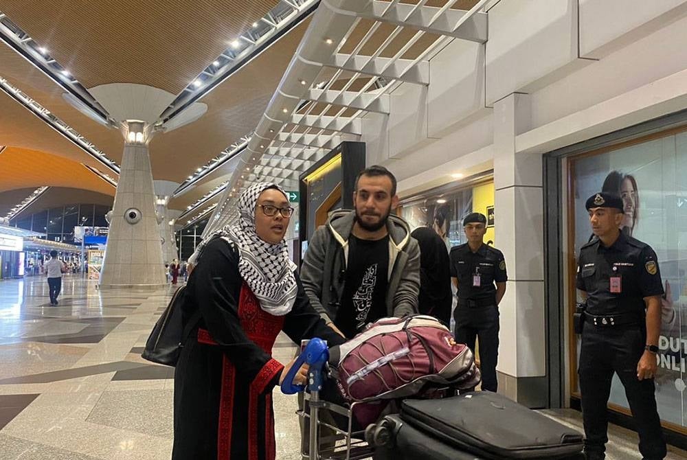 Nurul Ain (kiri) dan Mohamed Adan Shaat tiba di Terminal 1, KLIA pada Selasa.