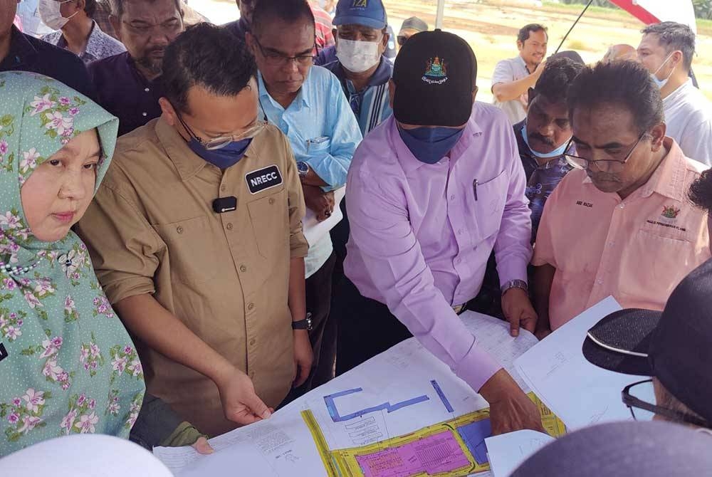 Nik Nazmi (dua kiri) diberi taklimat dan penerangan daripada pihak berwajib berhubung isu pembuangan minyak di tanah lapang kawasan perindustrian Bukit Kapar pada Khamis.