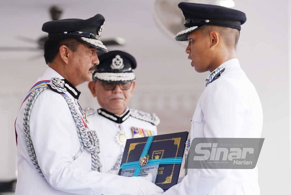 Razarudin menyampaikan anugerah Pelatih Terbaik Keseluruhan kepada Inspektor Khairul Anwar Khalid pada Majlis Pembarisan Tamat Latihan Program Latihan Asas Kepolisan (PLAK) Inspektor Pelatih Siri 1/2023 di Pusat Latihan Polis (Pulapol) Kuala Lumpur pada Jumaat. - FOTO SINAR HARIAN/ROSLI TALIB