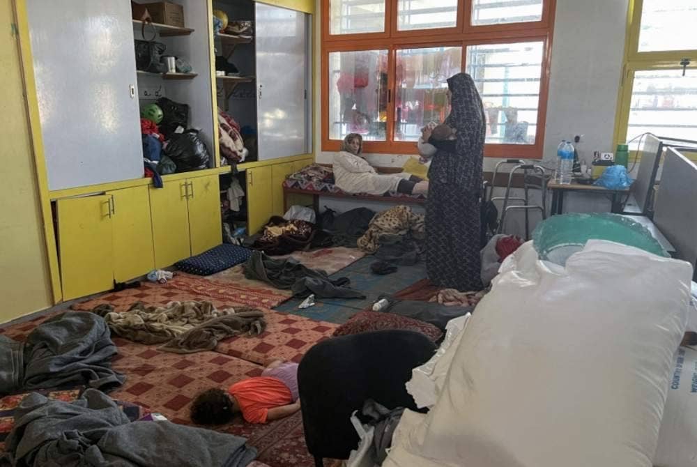 Fadwa Kullab yang berlindung di sekolah kendalian PBB di Rafah mengendong bayinya yang baru lahir.