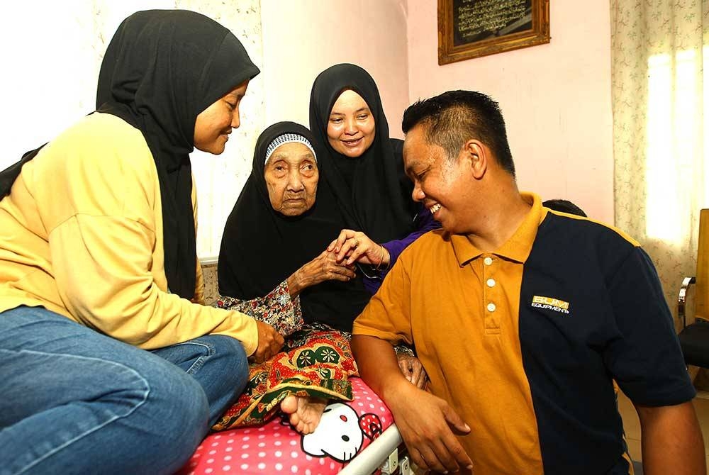 Uwan Lipah ditemani tiga daripada 11 cucunya.