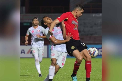 Pemain Negeri Sembilan FC, Casagrande mengasak PDRM, Muhammad Nur Iqmal Harun pada saingan Liga Super di Stadium Tuanku Abdul Rahman Paroi pada Sabtu.